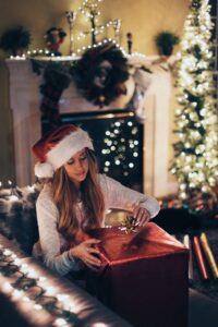 a woman wrapping a gift for christmas